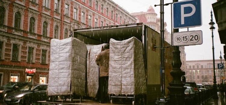A person loading a moving truck on a parking