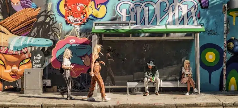 a woman passing a graffiti wall 