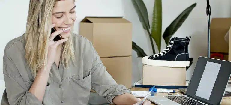 a woman on the phone talking about how interior designers benefit from moving services