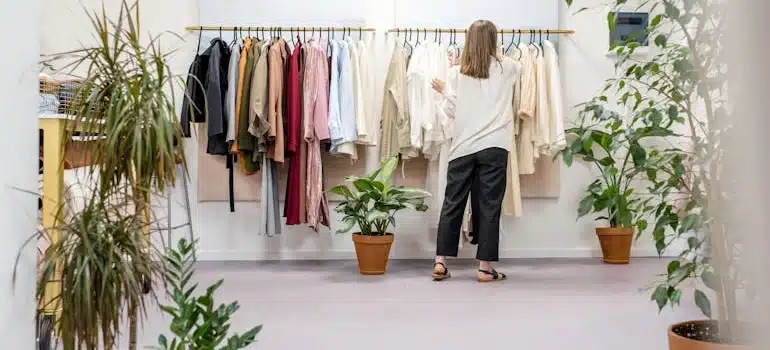 a woman checking clothes in a store