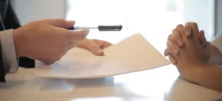 A mover offering a binding estimate to a woman to sign
