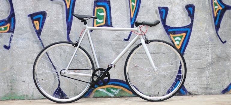 a bike next to a wall with graffiti