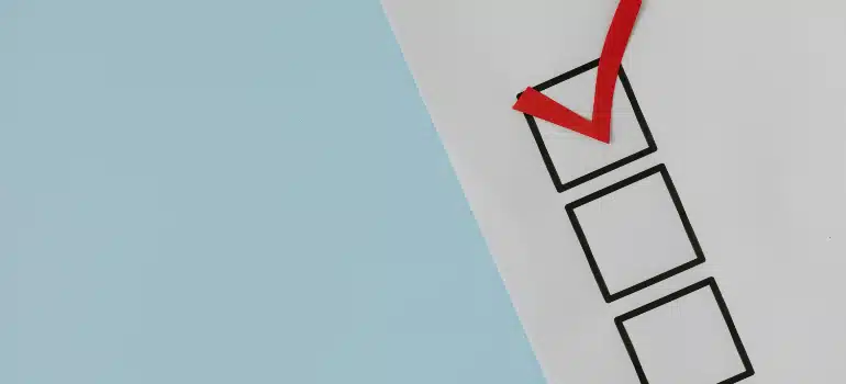Minimal checklist graphic with a bold red checkmark on a form.