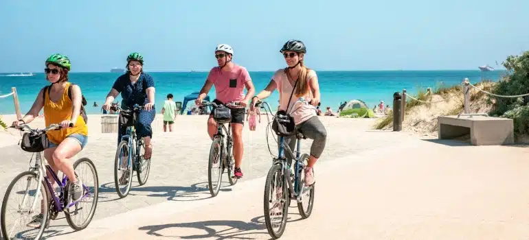 people riding bikes near the beach