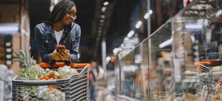 a woman buying groceries and thinking about the cost of living in Sunny Isles Beach