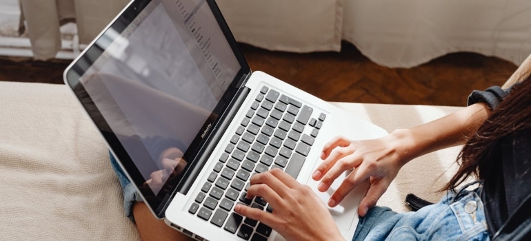 a girl researching the cost of living in Sunny Isles Beach on her laptop 