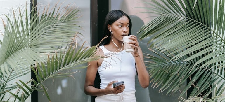 a woman drinking coffee thingking about the Fun Things to Do in Coconut Grove