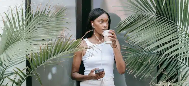 a woman drinking coffee thingking about the Fun Things to Do in Coconut Grove