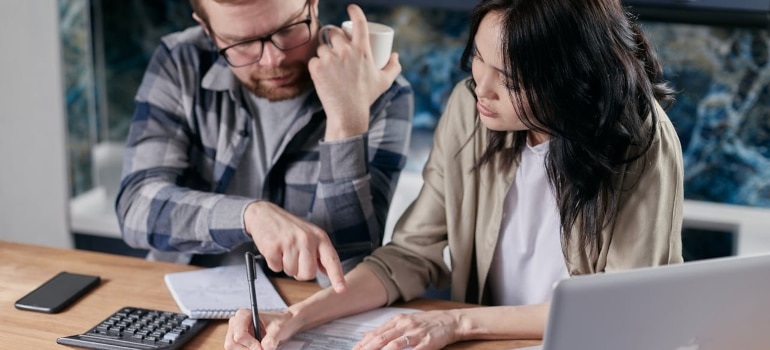 a couple calculating the cost of living in Sunny Isles Beach 
