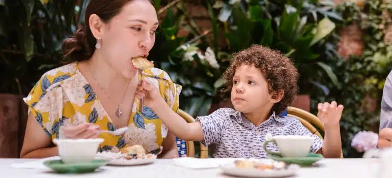 a child feeding a mother 