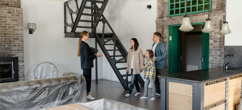 Realtor showing a family their potential new home, sparking excitement for the next step.