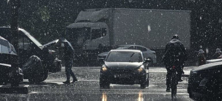 Cars and Pedestrians on the Street in Rain