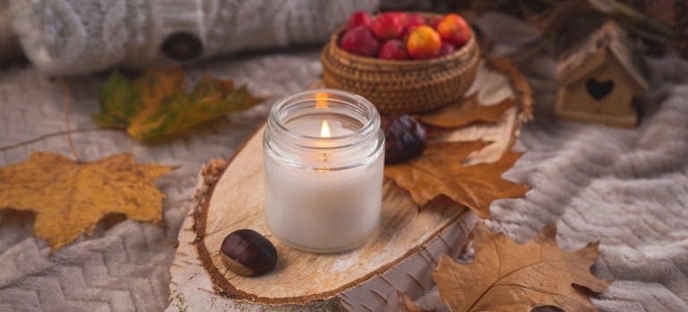A candle and dry leaves for decorating your Florida home for Thanksgiving