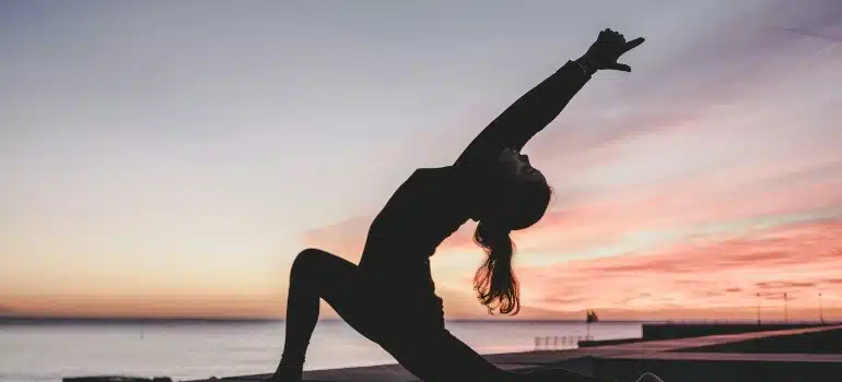 Person doing yoga to de-stress after a move in Miami