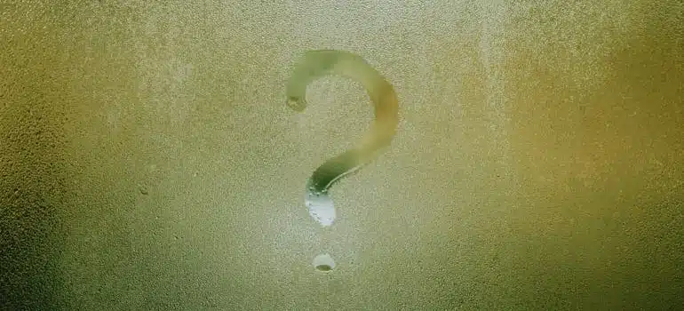 A question mark on a window fogged with condensation