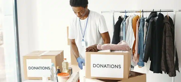 A man packing to donate unwanted items when relocating in Miami