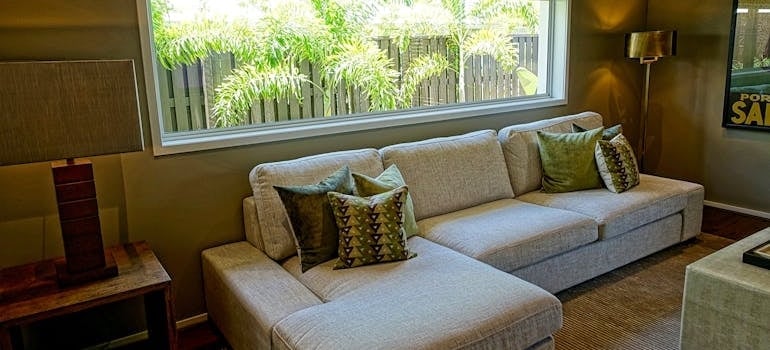 Gray Sectional Couch in front of a window