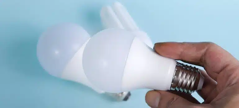 A Person Holding White LED Light Bulb