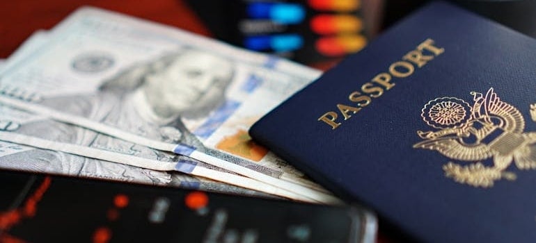 Close-up of Passport, Dollars, and Smartphone