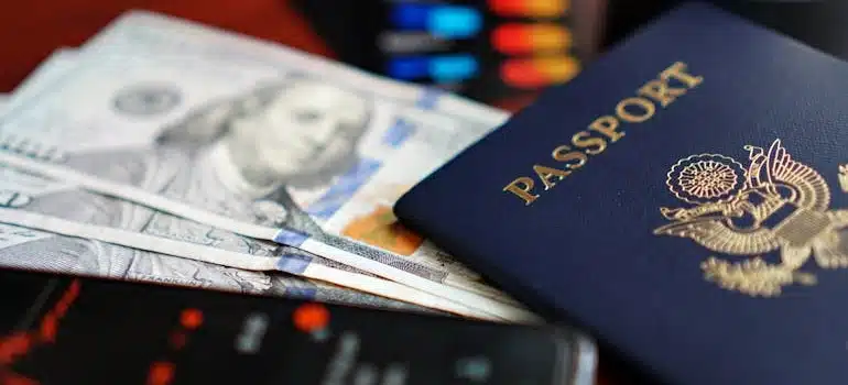 Close-up of Passport, Dollars, and Smartphone