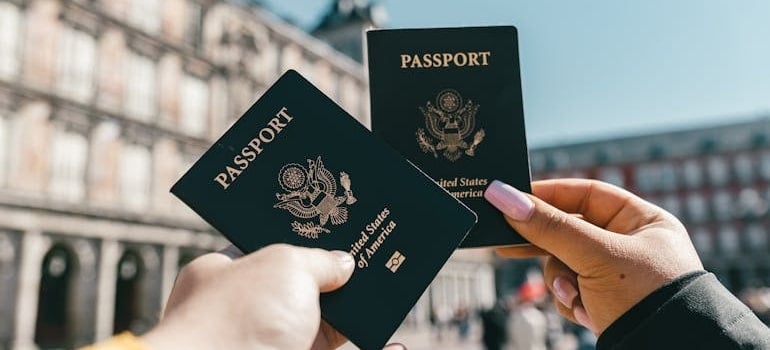 A couple in Italy showing passports after moving to Europe
