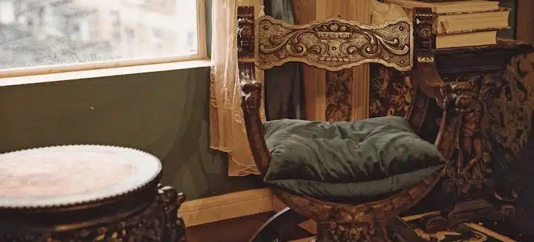 Antique wooden chair with a green cushion